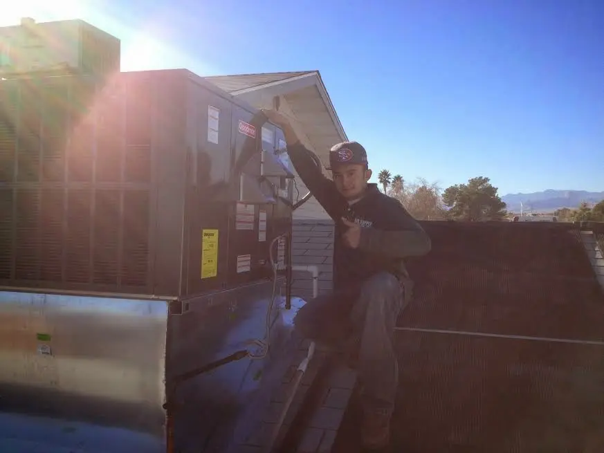 HVAC technician performing Boiler Repair on a rooftop unit in Hillsboro